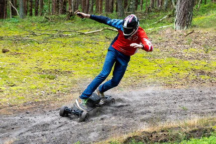 A man riding an electric skateboards through the forest