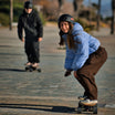 Riders enjoying Meepo electric skateboards in a sunny outdoor setting