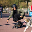 Woman riding Meepo skateboard with dog on a sunny day, showcasing urban mobility.