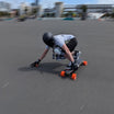 Skater performing a maneuver on a Meepo electric skateboard in a skate park.