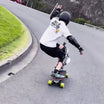 Rider executing a skateboard trick on Meepo board with green wheels.