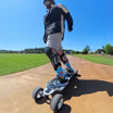 Rider using Meepo Vader electric skateboard on a sunny day